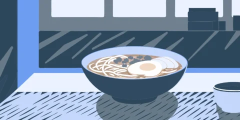 Steaming bowl of Nashville ramen with egg and toppings.