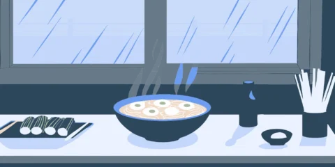Steaming noodle bowl with chopsticks at a noodle bar.