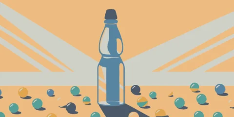 A bottle of Ramune, the classic Japanese marble soda, with its iconic glass marble stopper.